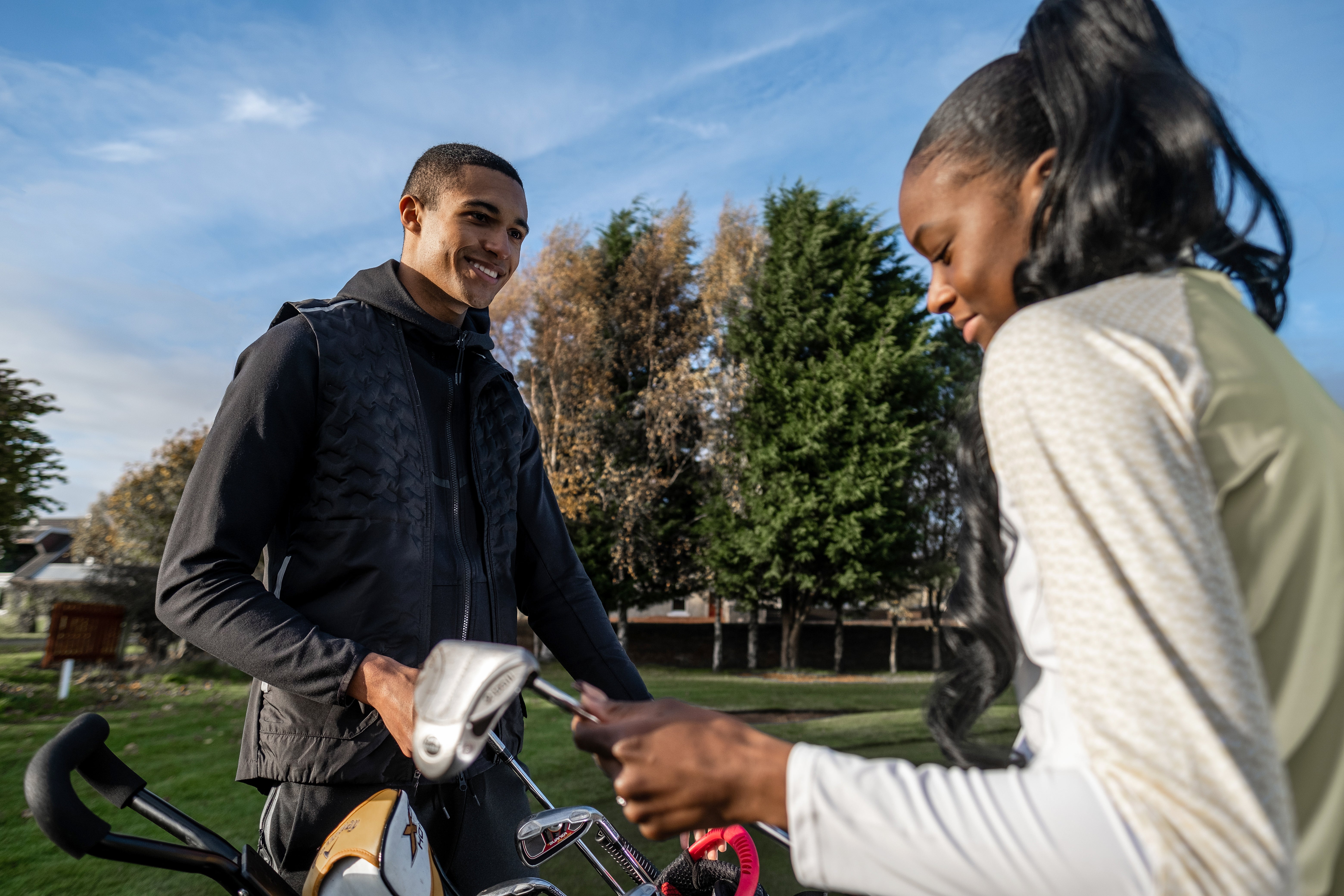 man and woman on golf course